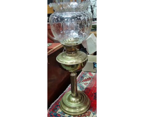 A brass oil lamp with clear glass shade, height including shade 58cm. 