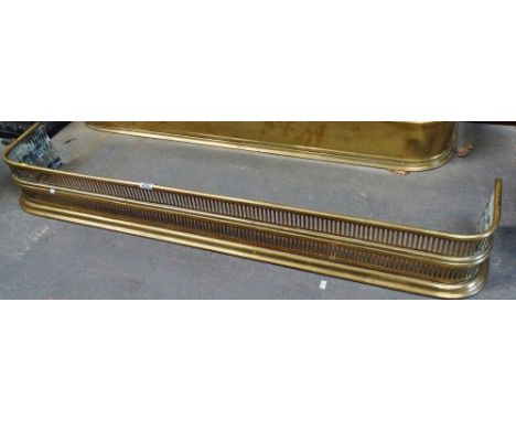 A pierced brass fender, width 120cm. 