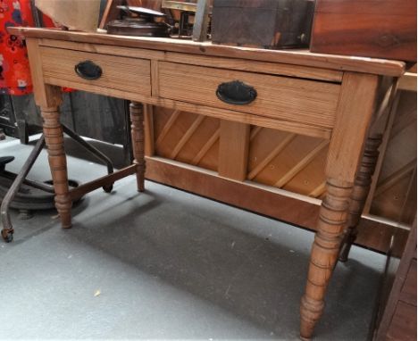 A late 19th century pitch pine dressing table fitted two drawers above turned legs with stretchers, width 110cm.