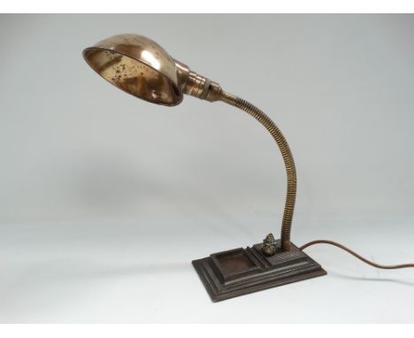 An early 20th century industrial swan neck brass adjustable table lamp upon cast iron base by Hawkins No.1018, cast marks to 