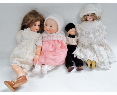 A German porcelain boy doll, together with an Armand Marseille 351/8.K. sleep eye doll and two other porcelain head dolls (4)