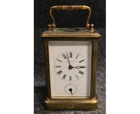 A French brass carriage clock in corniche case, the 2 inch white enamel dial with subsidiary hour dial and indistinctly signe