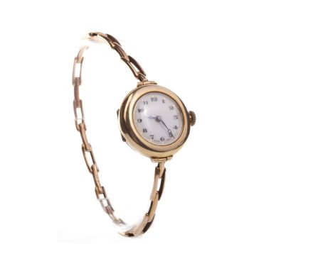 LADY'S EARLY TWENTIETH CENTURY NINE CARAT GOLD MANUAL WIND WRIST WATCH, the round white dial with black Arabic hour markers, 