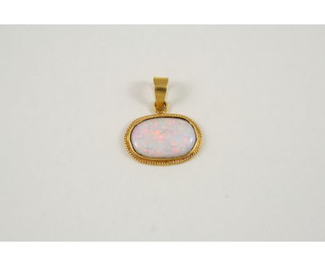 AN OPAL SINGLE STONE PENDANT the oval-shaped solid white opal is set in a gold mount, 2.5cm. wide.