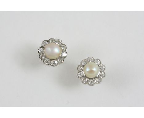 A PAIR OF DIAMOND AND PEARL CLUSTER STUD EARRINGS each untested pearl is set within a surround of ten old brilliant-cut diamo