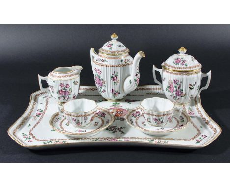 SAMSON STYLE TRAYED ARMORIAL BREAKFAST SET, 19th century, of moulded reeded form, painted in the famille rose palette with fl