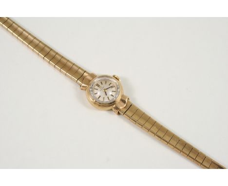 A LADY'S 9CT. GOLD WRISTWATCH BY OMEGA the signed circular dial with baton numerals, on a gold bracelet with ladder clasp, 21