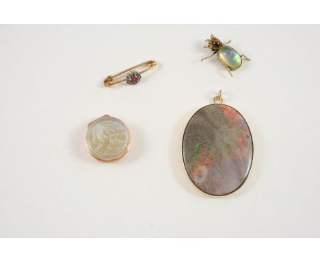 AN OPAL AND GOLD PENDANT the oval-shaped opal is set within a 9ct. gold mount, 4cm. long, together with a small mother-of-pea