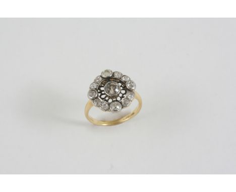 A DIAMOND CLUSTER RING the openwork design is centred with an old brilliant-cut diamond within a surround of further old bril