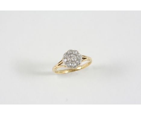 A DIAMOND CLUSTER RING the central old brilliant-cut diamond is set within a surround of smaller old brilliant-cut diamonds, 