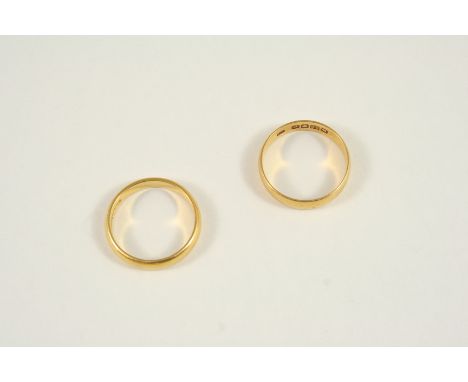 A 22CT. GOLD WEDDING BAND 4.1 grams, size R, together with another 22ct. gold wedding band, 5.5 grams, size P 1/2.