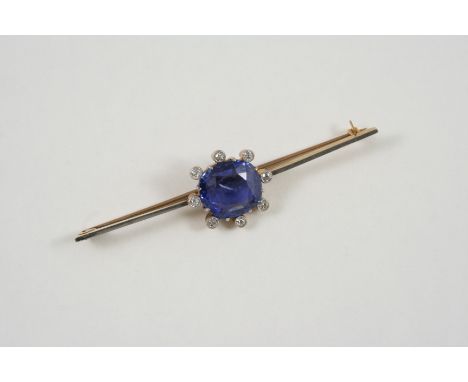 A SAPPHIRE AND DIAMOND BROOCH the cushion-shaped sapphire is set within a surround of circular-cut diamonds collet set in gol