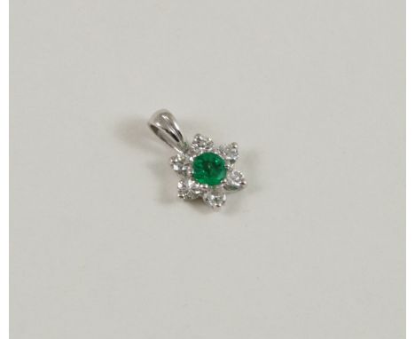 AN EMERALD AND DIAMOND CLUSTER PENDANT the circular-cut emerald is set within a surround of six circular-cut diamonds, in whi