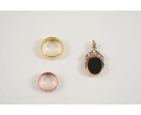 AN 18CT. GOLD WEDDING BAND 12.2 grams, size R, a 9ct. gold wedding band, 3.0 grams, size L, and a 9ct. gold spinning fob moun