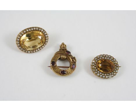 A CITRINE AND PEARL SET BROOCH the oval-shaped citrine is set within a surround of small pearls, in gold, 2.5cm. wide, togeth