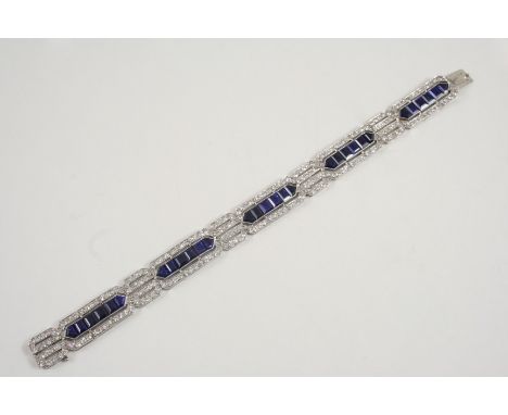 AN ART DECO SAPPHIRE AND DIAMOND BRACELET formed as five panels each centred with calibre-cut sapphires with a surround of mi