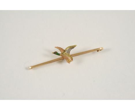 A 15CT. THREE COLOUR GOLD AND ENAMEL MALLARD BROOCH the gold bar mounted with a mallard in flight, the head with enamel decor