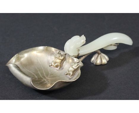 CHINESE NEPHRITE JADE AND WHITE METAL LADLE, the pale celadon belt hook handle with dragon head on a lotus leaf shaped bowl w