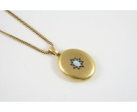 A VICTORIAN GOLD, OPAL AND DIAMOND LOCKET PENDANT the oval-shaped locket is mounted with an oval cabochon opal within a surro