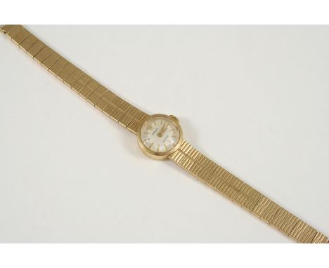 A LADY'S 9CT. GOLD WRISTWATCH BY ROLEX the signed circular dial with baton numerals, on an integrated gold bracelet with ladd
