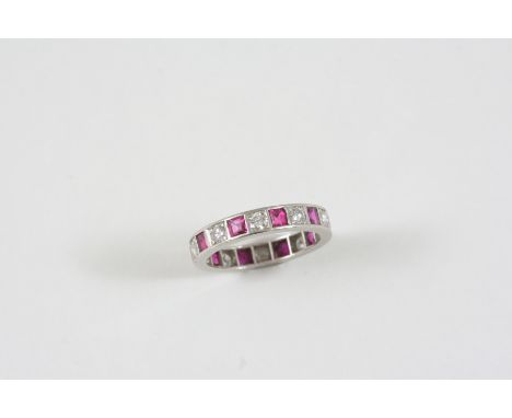 A RUBY AND DIAMOND FULL CIRCLE ETERNITY RING alternately set with circular-cut diamonds and square-shaped rubies. Size K 1/2.