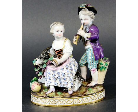 MEISSEN CHILDREN GROUP, 19th century, perhaps representing Autumn, he playing a recorder, she feeding grapes to a goat, blue 