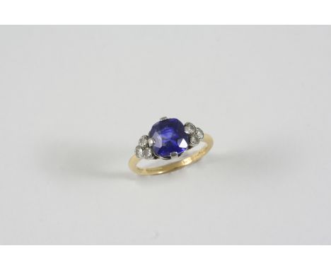 A SAPPHIRE AND DIAMOND RING the cushion-shaped sapphire is set with three old brilliant-cut diamonds to each shoulder, in gol