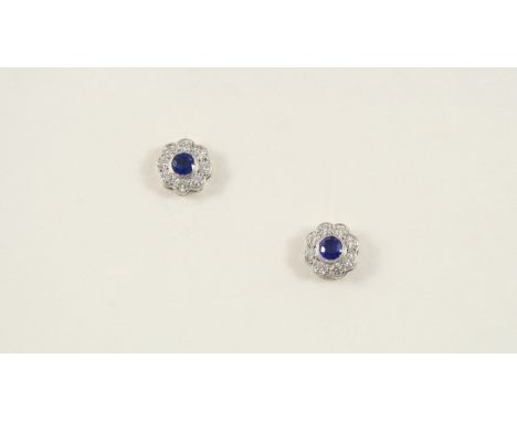 A PAIR OF SAPPHIRE AND DIAMOND CLUSTER STUD EARRINGS each earring set with a circular-cut sapphire within a surround of eight