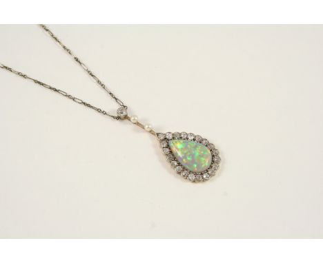 AN OPAL AND DIAMOND CLUSTER PENDANT the pear-shaped solid white opal is set within a surround of old brilliant-cut diamonds, 