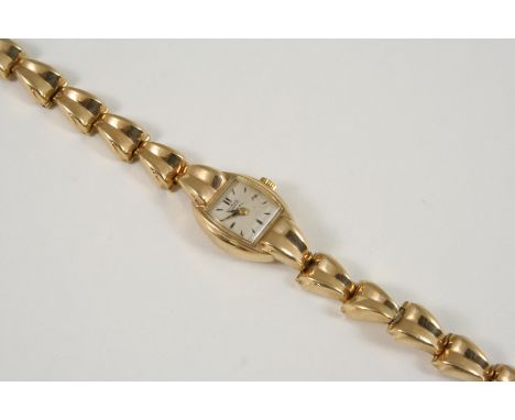 A LADY'S 9CT. GOLD WRISTWATCH BY TUDOR ROLEX the circular dial signed Tudor Royal, with dagger numerals, on an integrated gol