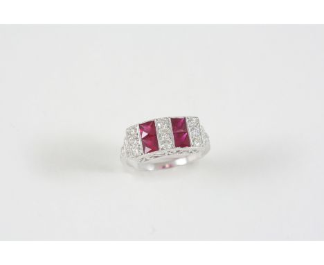 A RUBY AND DIAMOND RING the four calibre-cut rubies are set with circular-cut diamonds, in 18ct. white gold. Size O 1/2.