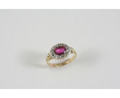 A RUBY AND DIAMOND CLUSTER RING the oval-shaped ruby is set within a surround of cushion-shaped diamonds, in gold. Size I.