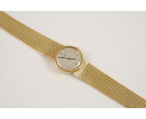 A LADY'S 18CT. GOLD WRISTWATCH WATCH the circular dial signed Universal Geneve and with baton numerals, on an integrated gold