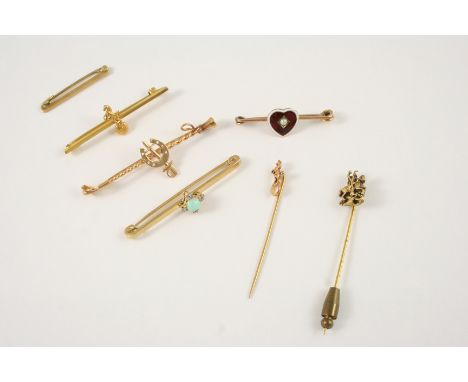 AN ENAMEL AND GOLD BROOCH the red quilloche enamel heart is centred with a small pearl, 4cm. long, an opal and diamond brooch
