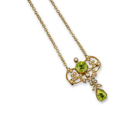 A Edwardian peridot and seed pearl pendant, set with two peridots within gold scrolling mount set with seed pearls, on gold c