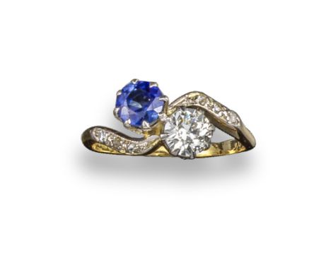 A sapphire and diamond crossover ring, set with a circular-cut sapphire and an old circular-cut diamond, with further diamond