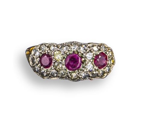 A ruby and diamond triple cluster ring, the circular-shaped rubies are set within a surround of single-cut diamonds in yellow