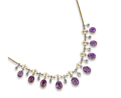 An Edwardian amethyst and goshenite necklace, the graduated oval-shaped amethysts suspend from seed pearls and are alternatel