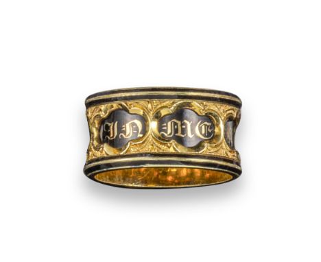 A mid 19th century gold mourning ring, the black enamel quatrefoil sections with 'In Memory Of' within engraved gold borders,