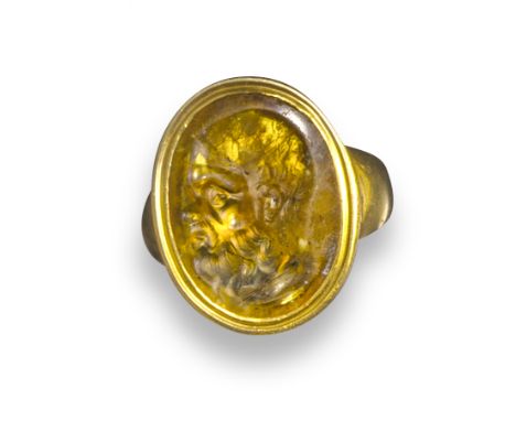 A mid 18th century citrine intaglio depicting Socrates, in a later gold ring, 2.1cm high, ring size K 1/2 (approximately)