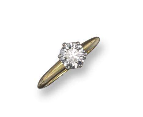 A diamond solitaire ring by Tiffany &amp; Co., the round brilliant-cut diamond weighs 1.04cts and is Tiffany-set® in yellow g