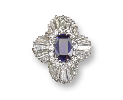 A sapphire and diamond ballerina cluster ring, centred with an oval-shaped sapphire within an undulating surround of round br