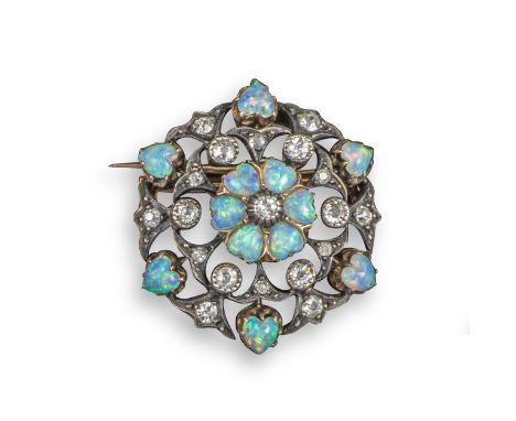 An Edwardian opal and diamond circular brooch pendant, centred with a circular-cut diamond within a heart-shaped opal surroun