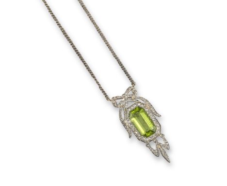 An early 20th century peridot and diamond pendant, the emerald-cut peridot is set within a surround of rose-cut diamonds in p