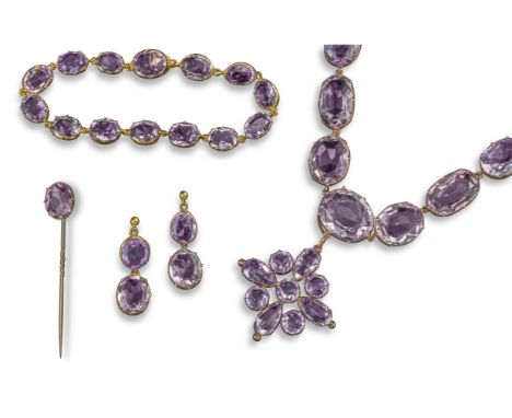 A Victorian amethyst rivière necklace, set with graduated oval-shaped amethysts in gold collets, suspending a flowerhead pend