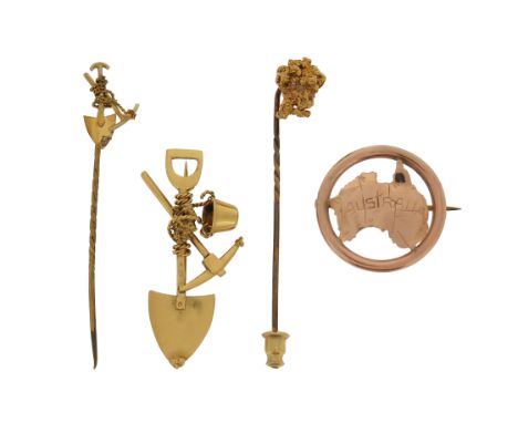 An Australian gold mining brooch, formed as a pick-axe, shovel and bucket, 4cm wide, with a matching gold stickpin, a gold nu