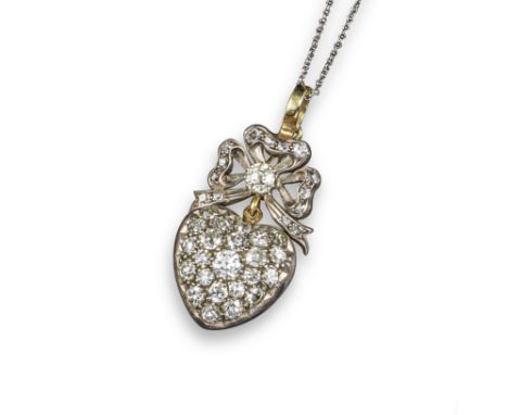 A Victorian diamond heart pendant, pave-set with graduated cushion-shaped diamonds and suspended from a diamond-set bow in si