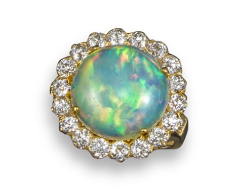 An opal and diamond cluster ring by Tiffany &amp; Co, the opal cabochon set within a surround of old circular-cut diamonds in