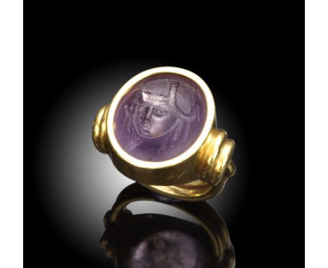 A Hellenistic amethyst intaglio probably depicting an Egyptian queen, mounted in a gold ring, intaglio 1.7cm high, ring size 