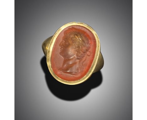 A carnelian intaglio depicting a young Claudius Caesar laureate, possibly provincial Ancient Roman, in later gold ring mount,